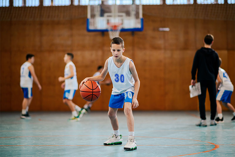 Young athlete dribbling basketball